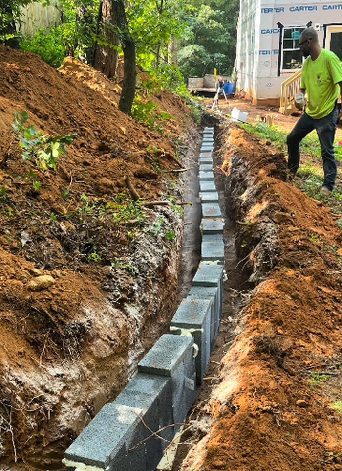 Crew laying block-lined septic trench on a Troutman, NC jobsite